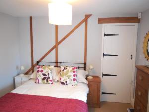 a bedroom with a bed and a white door at Wishing Well Cottage in Wilmington