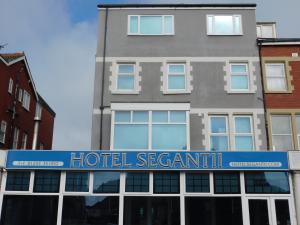 
a blue and white building with a blue sky at Hotel Segantii in Blackpool
