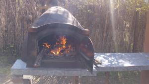 a stone oven with a fire in it at Luz Del Alma in Las Gaviotas +47 photos