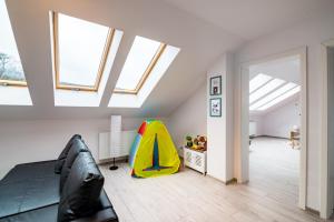 a attic room with skylights and a room with a tent at Apartament Rodzinny Mountain Aparts in Świeradów-Zdrój
