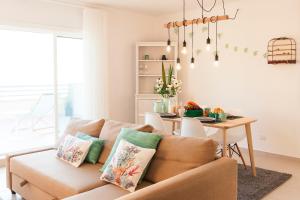 a living room with a couch and a table at Home Sweet Praia Penthouse in Nazaré