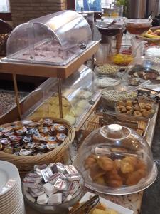 a buffet filled with lots of different types of food at Acropole Delphi City Hotel in Delphi