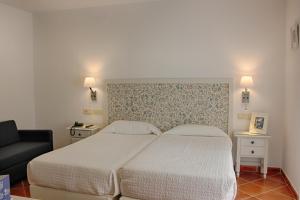 Кровать или кровати в номере Hotel Malaga Picasso