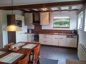 a kitchen with a table and a dining room at Vakantiewoning Kleijnen in Noorbeek