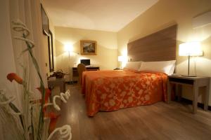 Postel nebo postele na pokoji v ubytování Hotel Centro Los Braseros