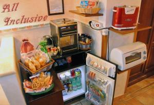 a small kitchen with an open refrigerator with food at Hotel Barrett in Rome