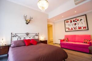 una camera con letto e divano rosa di Cà do Franco a Chiavari