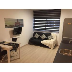 a living room with a couch and a table at Apartahotel Baldiri in Sant Boi del Llobregat