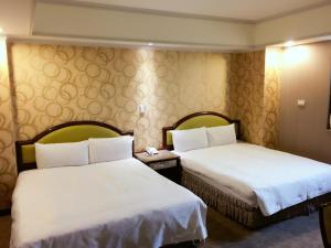 Giường trong phòng chung tại Unic Hotel