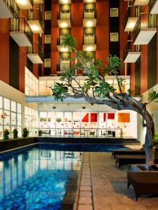a swimming pool in a building with a hotel at Amaris Hotel Kupang in Kupang