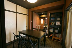 a dining room with a table and two chairs at Daisenji Lodge Ing 墨 地下鉄鞍馬口駅から徒歩1分 in Kyoto