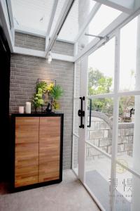 a pivot door in a room with a balcony at Man Man Bnb in Hualien City