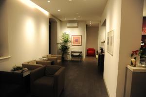 a living room with couches and a waiting room at Albergo Al Sole in Mezzolombardo