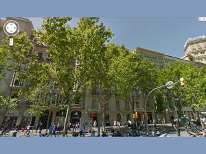 a building with a clock on the side of a street at Passeig de Gracia Studio Loft in Barcelona