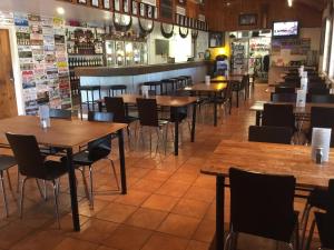 a row of tables and chairs in a restaurant at Roebuck Plains Roadhouse in Broome