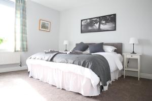 a white bedroom with a large bed and a window at Holiday Home Elerkin in Durham