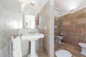 a bathroom with a sink and a toilet at Casa Malu in Positano