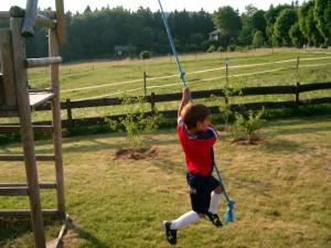 a young boy playing on a rope swing at Haus Jasmin in Sankt Andreasberg