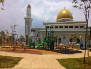 a playground in front of a mosque with a dome at Seri Endon Apartment in Shah Alam