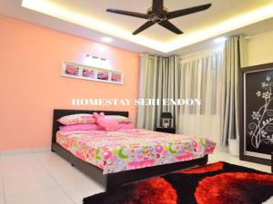 a bedroom with a pink bed and a ceiling fan at Seri Endon Apartment in Shah Alam
