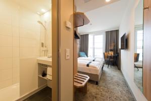 Postel nebo postele na pokoji v ubytování LOGINN Hotel Leipzig