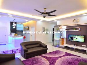 a living room with a couch and a ceiling fan at Seri Endon Apartment in Shah Alam