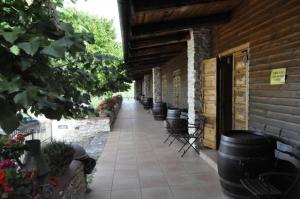 a patio with a row of black barrels next to a building at Tenuta Tannoja in Andria