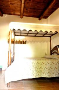 a bed with a canopy in a room at Tenuta Tannoja in Andria