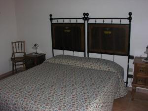 a bedroom with a bed and a dresser and a chair at Tenuta Tannoja in Andria