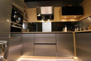 a kitchen with stainless steel cabinets and appliances at Center palais in Cannes