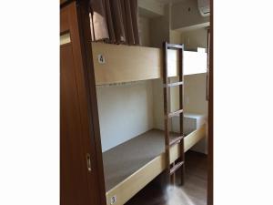an open door to a bunk bed in a room at Yamate Rest House (Male Only) in Tokyo