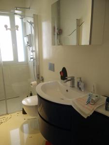 a bathroom with a sink and a toilet and a mirror at Miro' Holiday Attic in Bologna