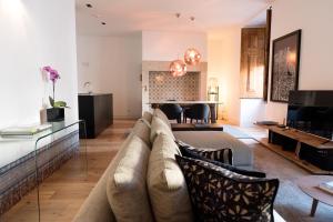 a living room with a couch and a table at Flora Chiado Apartments in Lisbon