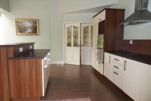 a kitchen with white cabinets and black counter tops at Ethan House in Killarney