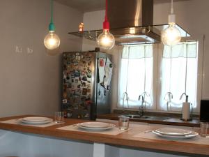 a kitchen with a counter with plates and a refrigerator at BnB Anacleto in Bassacutena +93 photos