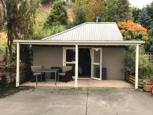 a pavilion with a table and chairs on a patio at Blair Athol Accommodation in Balclutha