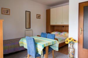 a room with a table and chairs and a bed at Apartmaji Tim in Izola