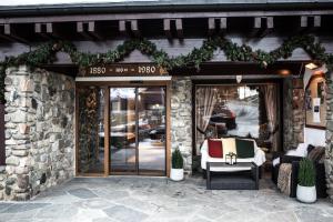 a store front with a door with a chair outside at Geilo Hotel in Geilo