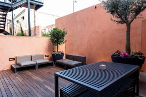 a patio with a table and chairs on a deck at Flora Chiado Apartments in Lisbon