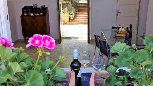 a table with a bottle of wine and some flowers at Casa Lorenzo in Porticello