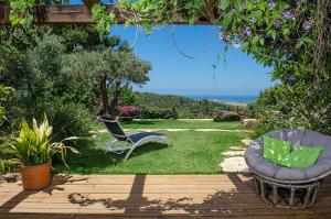 a patio with a chair and a chair at Above the Sea in Ein Hod