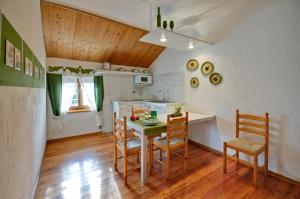 a kitchen and dining room with a table and chairs at Sembenini Palace in Riva del Garda