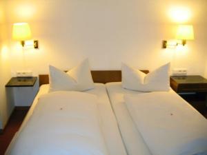 Ένα ή περισσότερα κρεβάτια σε δωμάτιο στο Eintracht Hotel