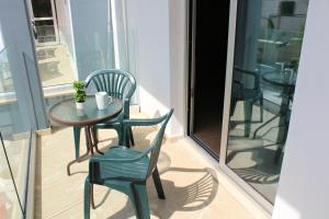 a small table and chairs on a balcony at Maria Zintili Apartments in Ayia Napa