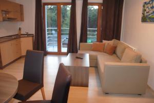 a living room with a couch and a table at Villa Camp in Jurata