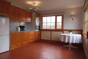 a kitchen with a table in the middle of it at Arina Holiday House in Nasva