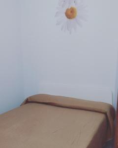 a bed in a room with a flower on the wall at Casa Vacanze Spadafora 2 in Spadafora