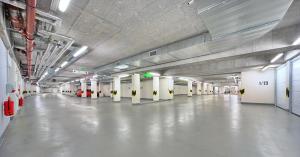 a large empty parking garage with white floors and white columns at Suites and Apartments Medvědín in Špindlerův Mlýn