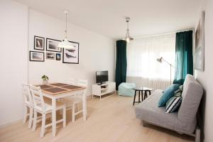 a living room with a table and a dining room at Heaven in Hel 1 in Hel