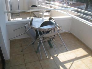 a table and chairs in a room with a window at Apartments Circle Olive in Ulcinj